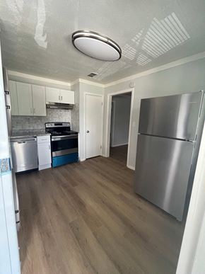 Riverdale apartment for rent - a renovated kitchen with stainless steel appliances and white cabinets