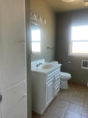 Santa Maria house for rent - A bathroom with a toilet, sink, and a window.