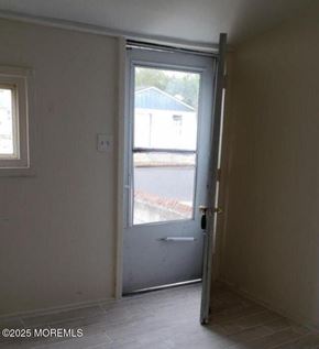 Keansburg apartment for rent - A room with a door leading to a balcony.