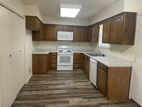 Georgetown apartment for rent - an empty kitchen with wooden floors and white appliances