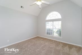 Memphis house for rent - a bedroom with a ceiling fan and a window