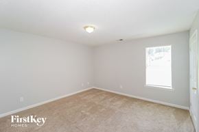 Memphis house for rent - the spacious living room with carpeting and a window