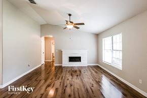 Orange City house for rent - A spacious room with a fireplace and a ceiling fan.