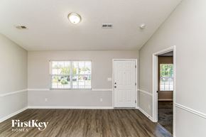 High Point house for rent - A room with a wooden floor and a white door.