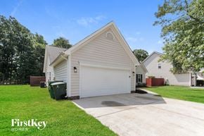 Charlotte house for rent - A house with a garage and a driveway in front of it.