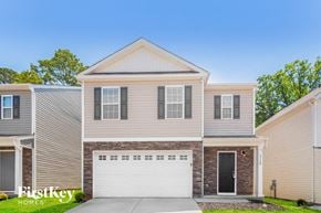 Dallas house for rent - a tan house with a white garage door