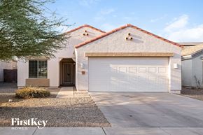 Phoenix house for rent - A house with a white garage door is for sale.