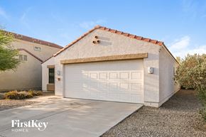 Phoenix house for rent - A garage with a white door is attached to a house.
