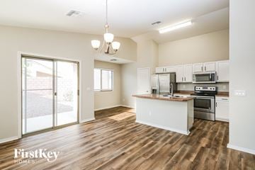 Phoenix house for rent - A kitchen with a wooden floor and white walls.