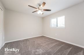Lehigh Acres house for rent - a bedroom with a ceiling fan and a window