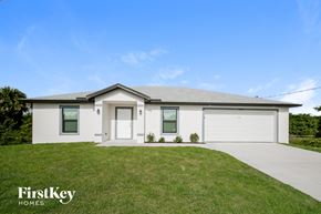 Lehigh Acres house for rent - A modern house with a white exterior and a grey roof.