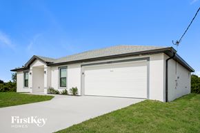 Lehigh Acres house for rent - A two-story house with a garage on the side.