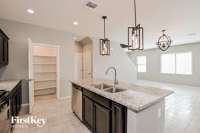 Tucson house for rent - A kitchen with a granite countertop and a sink.