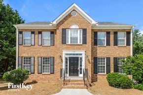 Winston-Salem house for rent - a brick house with black shutters and a black front door