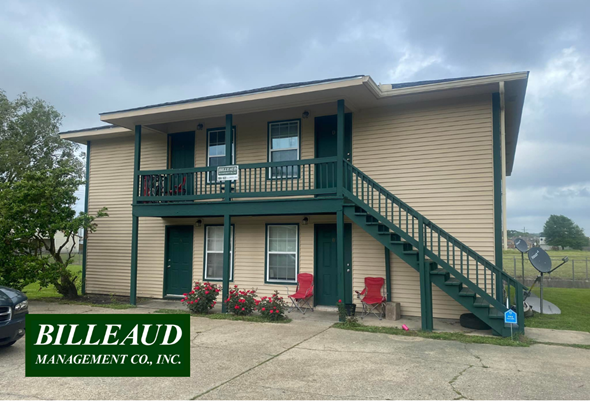 Lafayette apartment for rent - a yellow house with green stairs and a green balcony