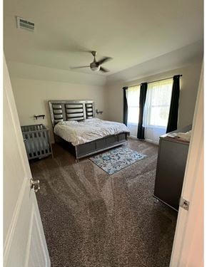 Youngsville house for rent - a bedroom with a crib and a bed and a ceiling fan