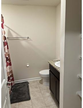 Youngsville house for rent - a bathroom with a toilet and a shower and a sink
