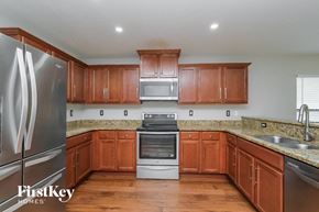 Riverview house for rent - a kitchen with wooden cabinets and stainless steel appliances