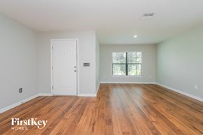 Riverview house for rent - the master bedroom with hardwood flooring and a white door