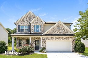Cumming house for rent - a brick house with a white garage door