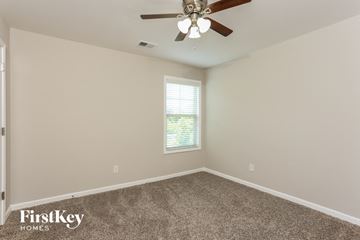 Cumming house for rent - the living room has a ceiling fan and a carpet