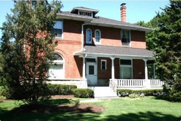 Western Springs apartment for rent - a red brick house with a porch and a tree