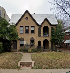 Dallas apartment for rent - A brick house with a triangular roof and a sign in front.