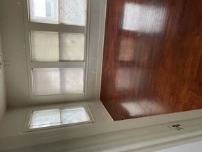 Dallas apartment for rent - A window with a white frame is in a room with wooden walls.
