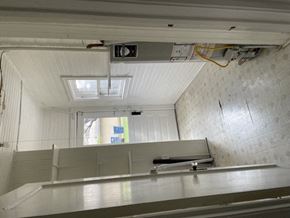 Dallas apartment for rent - A white ceiling with a skylight and a white wall with a window.