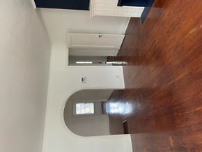 Dallas apartment for rent - A white wall with a window and a brown wooden wall.