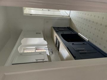 Dallas apartment for rent - A white kitchen with a dishwasher and sink.