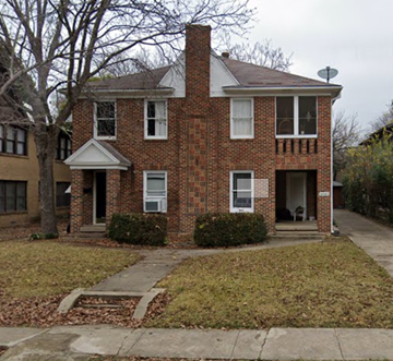 Dallas apartment for rent - a brick house with a sidewalk in front of it
