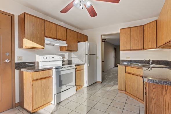Naperville apartment for rent - A kitchen with wooden cabinets and a white refrigerator.