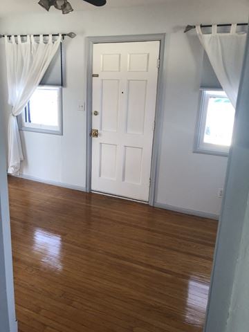 San Diego apartment for rent - an empty room with a wooden floor and a white door