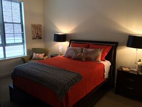 Baltimore apartment for rent - a bedroom with a bed and two lamps and a window