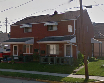 Houston apartment for rent - a red house with a porch and a white fence