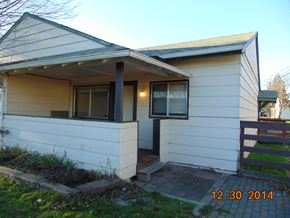 Eagle Point apartment for rent - A house with a white siding and a black door.