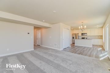 Colorado Springs house for rent - A spacious living room with a kitchen in the background.