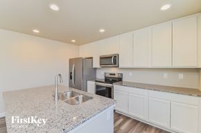 Colorado Springs house for rent - A kitchen with a granite countertop and stainless steel appliances.