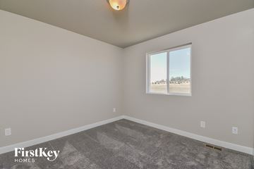 Colorado Springs house for rent - the living room of a house with carpet and a window