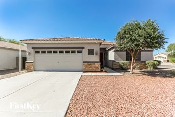 Phoenix house for rent - a white house with a driveway and a garage door