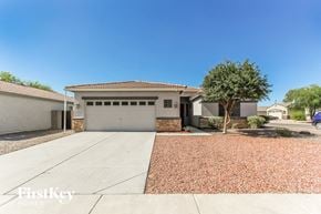 Phoenix house for rent - a house with a driveway and a garage door