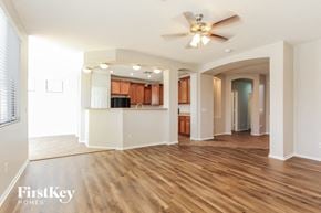 Phoenix house for rent - a living room and kitchen with wood flooring and a ceiling fan