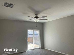 Colorado Springs house for rent - an empty room with a ceiling fan and a window