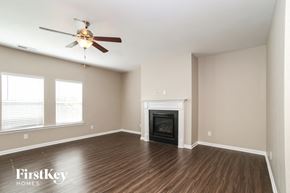 Canton house for rent - A room with a fireplace and a ceiling fan.