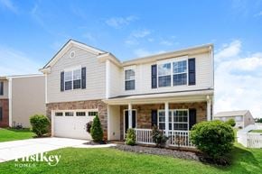 Gastonia house for rent - A two-story house with a garage and a front porch.