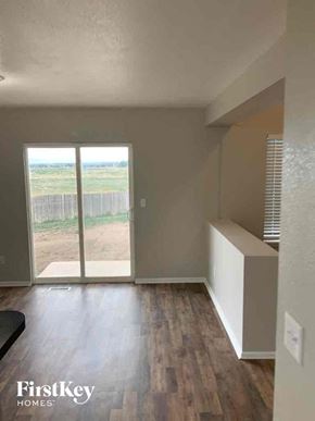 Fountain house for rent - an empty living room with a sliding glass door to a patio