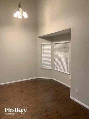 Fountain house for rent - A room with wooden floors and white walls.
