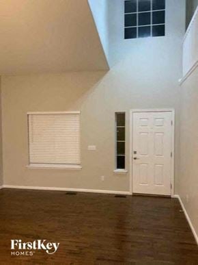 Fountain house for rent - A room with a white door and a window with blinds.