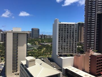 Honolulu apartment for rent - A cityscape with various buildings and a clear blue sky.
